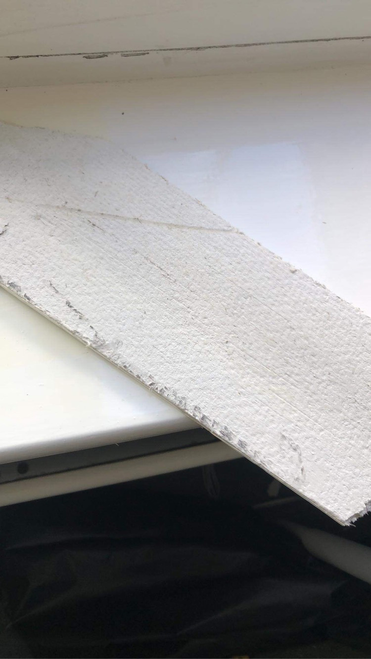 The confirmation photo - small section of AIB on windowsill showing the textured back that raised suspicion, sent to dad and shown to neighbour