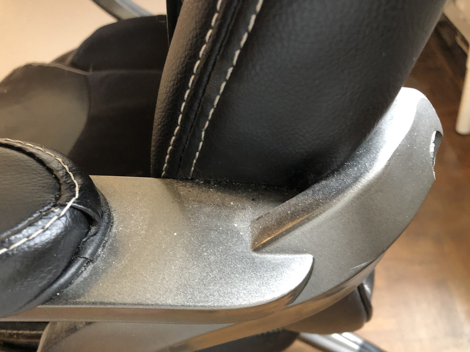 Visible dust remaining on office chair after inadequate cleaning