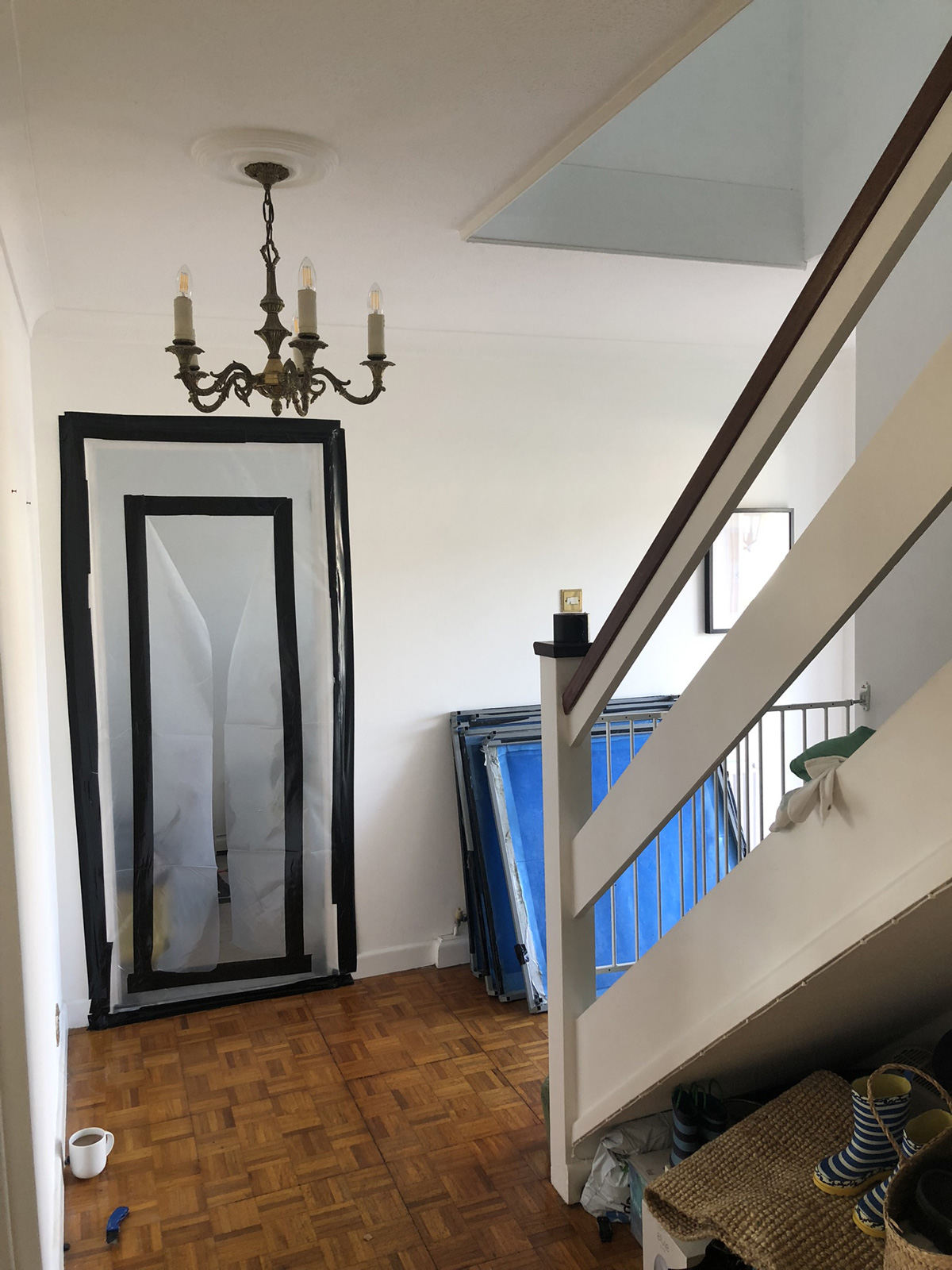 Enclosure panels arriving - can still see into office through plastic sheeting