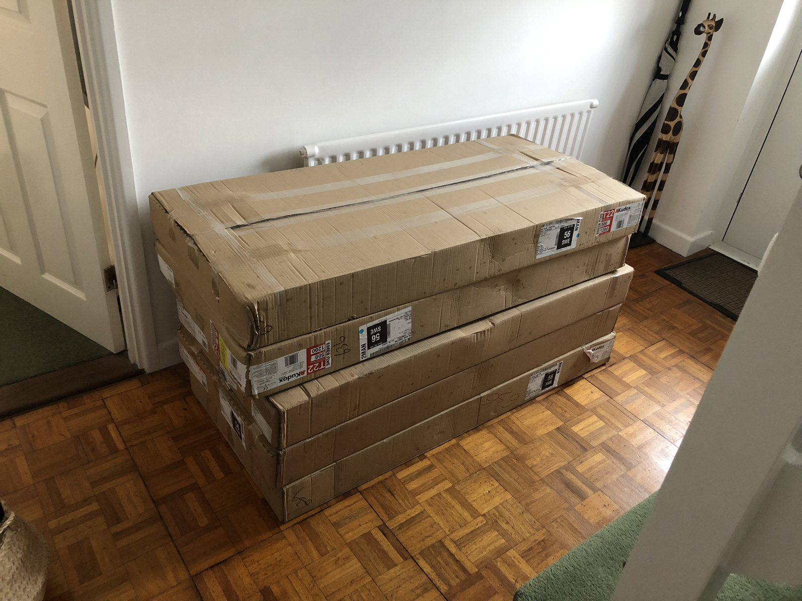 Stack of new Kudox radiators delivered and waiting in hallway