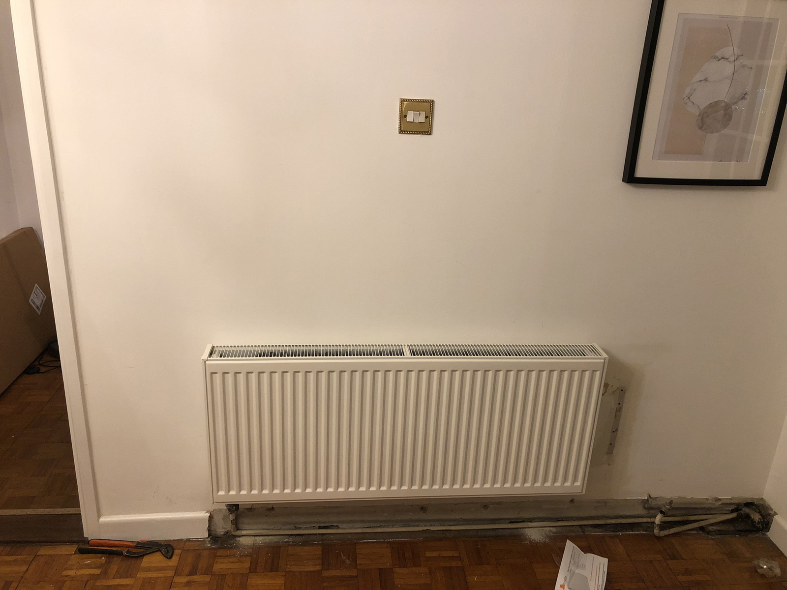 Newly hung radiator showing bracket installation