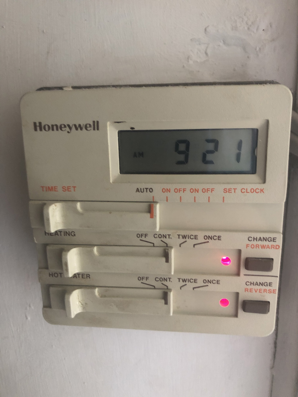Old Honeywell timer controlling heating and hot water - part of the inefficient conventional boiler system with separate hot water cylinder