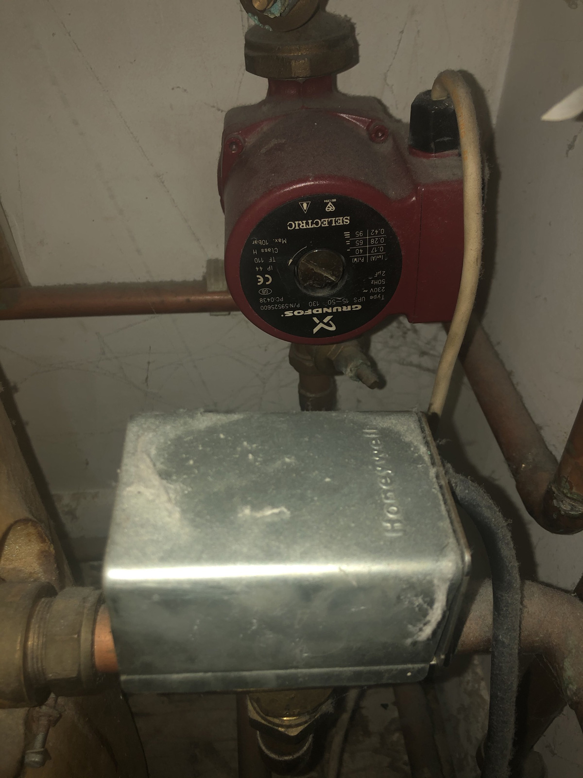 Honeywell diverter valve routing heat between radiators and hot water cylinder - showing the complexity of the old conventional system