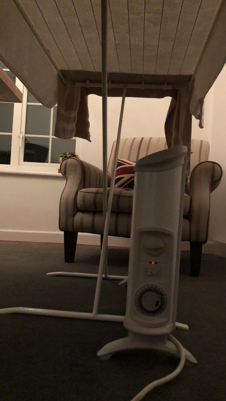 Drying towel with convection heater beneath clothes horse