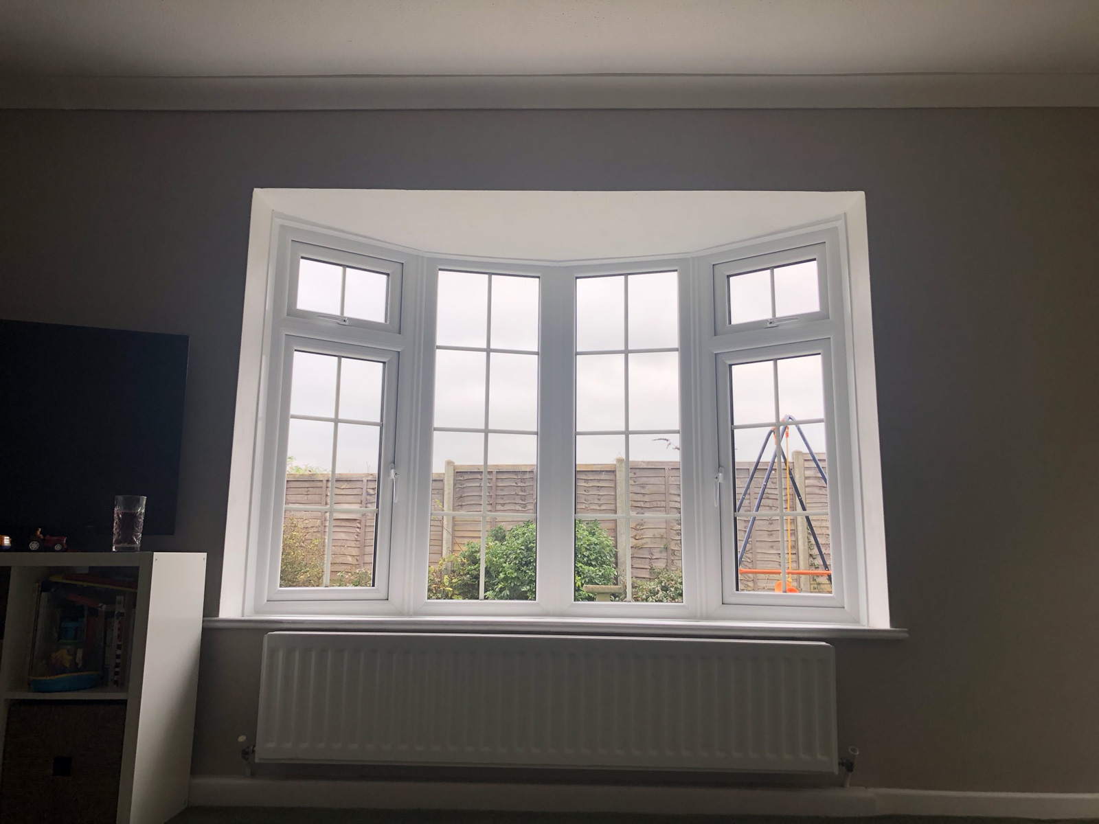 Completed living room bay window with modern double glazing - dramatic improvement over 1970s windows