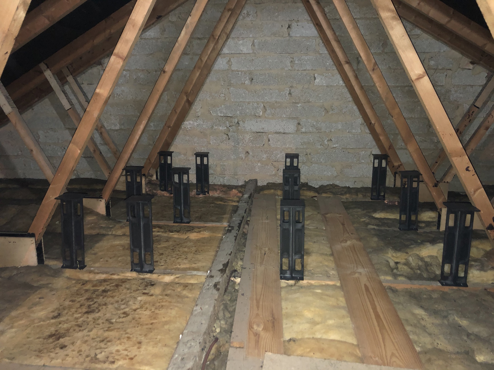 Cramped loft working conditions showing limited headroom